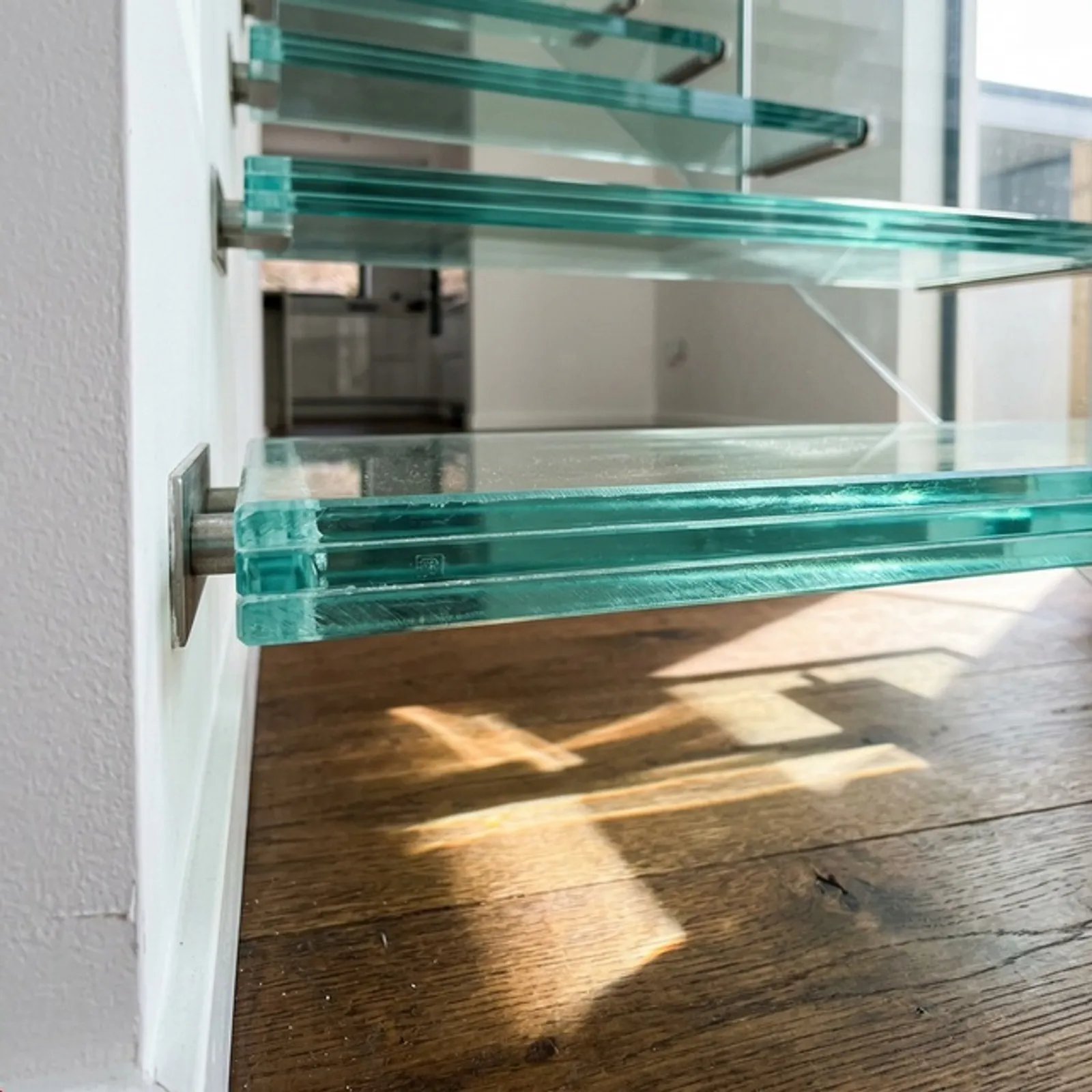 Glass tread cantilevered staircase showing light flow and open sightlines
